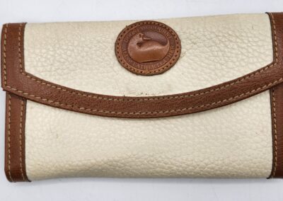 Cream and brown leather wallet with logo.
