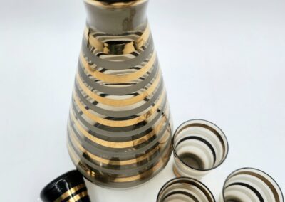 Striped glass decanter with stopper and glasses.