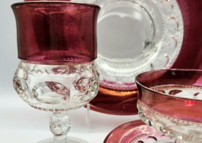 Red and clear glassware set on display.