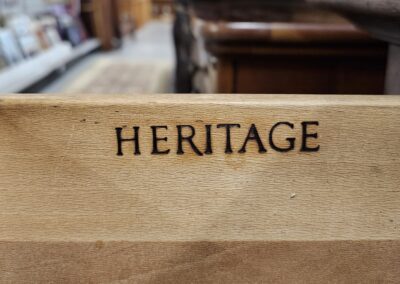Wooden sign with 'Heritage' engraved on it.