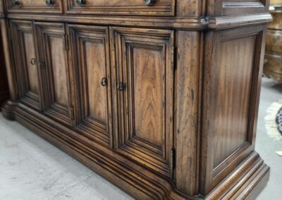 Wooden vintage sideboard with ornate detailing.