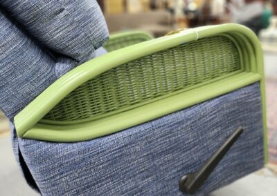 Blue recliner chair with green armrest detail.