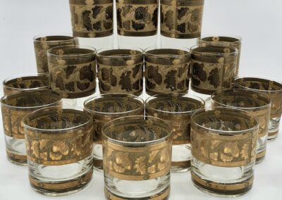 Vintage glasses with ornate gold patterns displayed.
