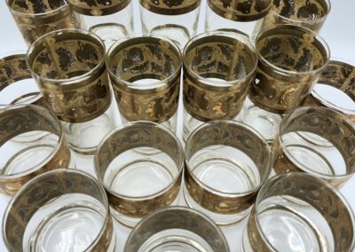 Gold-trimmed glassware set arranged in pyramid.