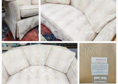 Beige fabric sofa with floral pattern detailing.