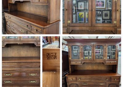 Wooden hutch with glass cabinets and drawers.