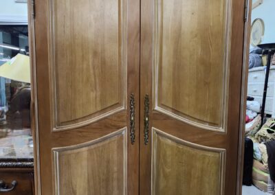 Ornate wooden armoire in antique style.