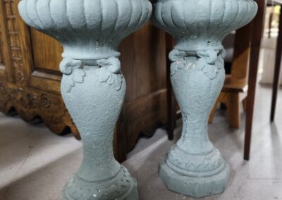 Two ornate teal pedestal stands indoors.