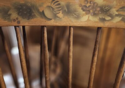 Wooden chair with decorative backrest design.