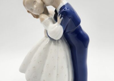 Porcelain figurine of couple kissing.