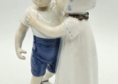 Porcelain figurines of a boy and girl.