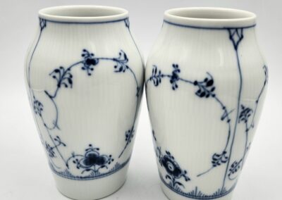 Two white vases with blue floral patterns.