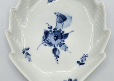 Leaf-shaped porcelain dish with blue floral design.