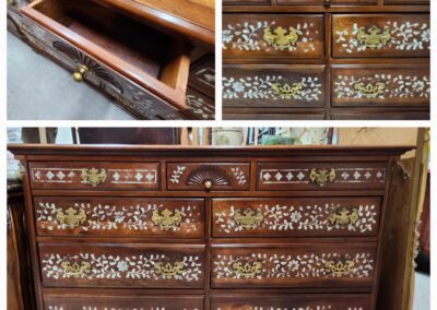 Wooden dresser with ornate floral inlay design.