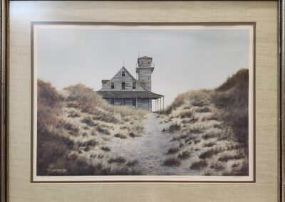 Old house on a sandy, grassy path.