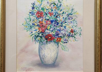 Framed floral painting in a decorative vase.