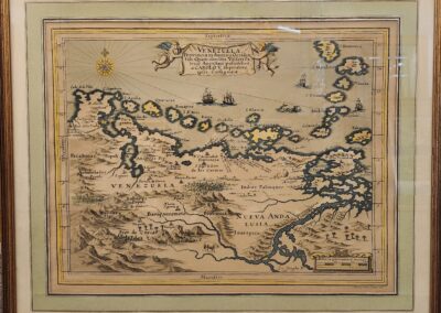 Framed antique map with detailed illustrations.