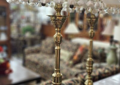 Brass lamps with white shades in store.