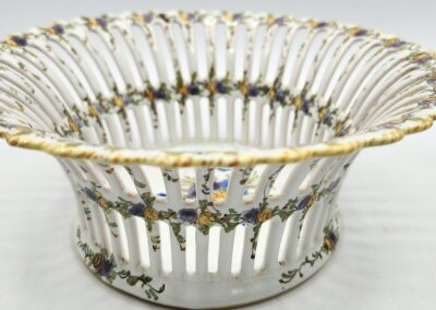 Ornate ceramic basket with floral design.