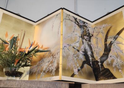 Decorative folding screen with floral arrangement.