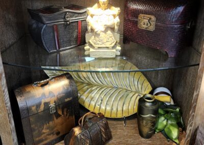 Decorative shelf with statue and vintage items.