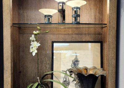 Decorative shelf with plants and ornaments.