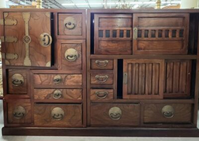 Antique wooden cabinet with multiple drawers.