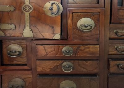 Wooden cabinet with brass handles and hinges.