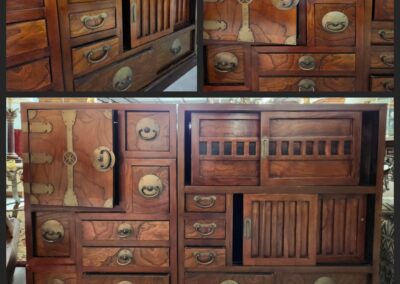 Wooden cabinet with multiple drawers and handles.