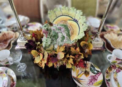 Festive table setting with decorative turkey centerpiece.