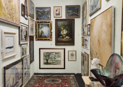 Art gallery hallway with framed paintings displayed.