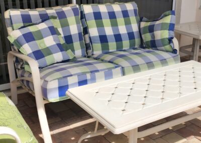 Outdoor patio with checkered cushions and table.