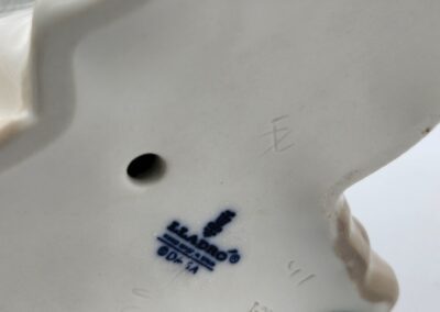 Porcelain figurine base with Lladró stamp.