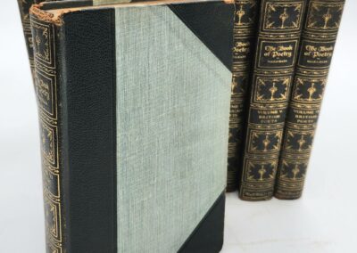 Antique books, leather-bound with ornate spines.