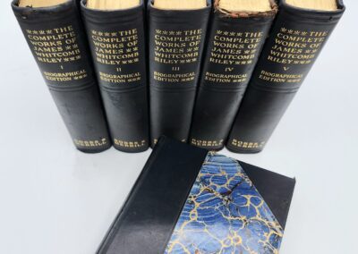 Five vintage books with decorative cover design.