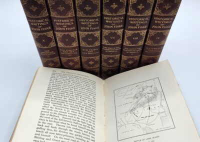 Set of historical books with open pages.