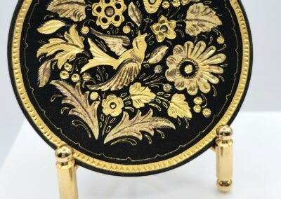 Gold floral plate with coin for scale.