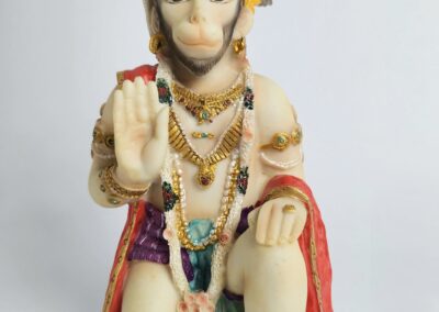Hanuman statue with raised hand blessing.