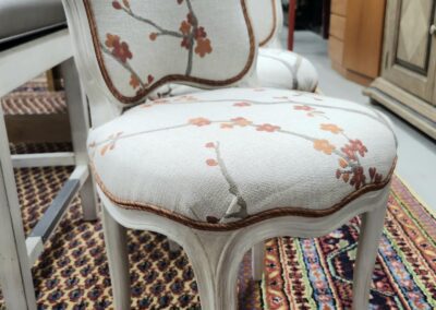 Vintage floral chair on patterned rug.