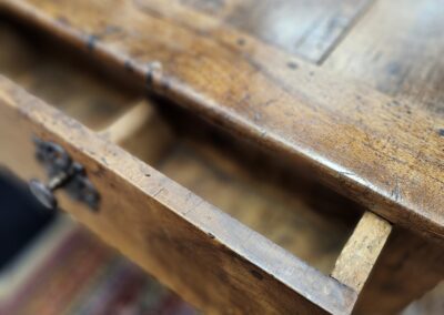 Open wooden drawer with vintage handle.