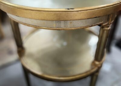 Gold round table with glass top.