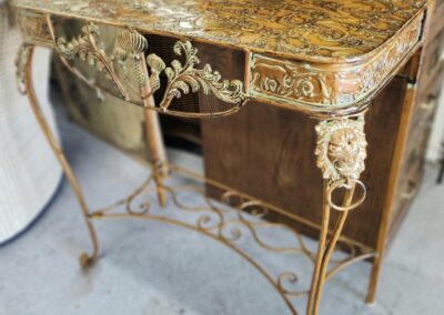 Ornate vintage table with intricate floral design.