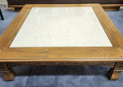 Wooden coffee table with marble top.