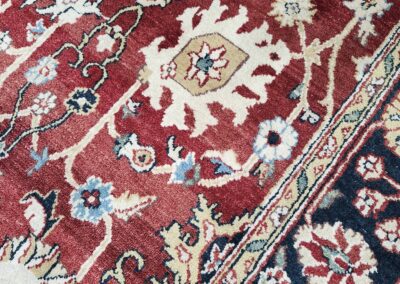 Ornate red and blue floral patterned rug.