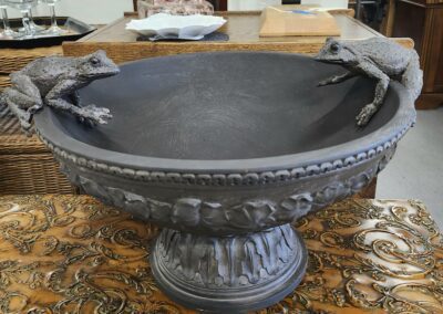 Decorative bowl with frog sculptures on rim.