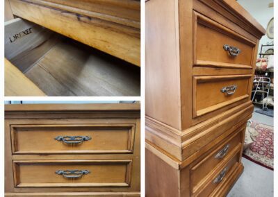 Wooden dresser with ornate drawer handles.