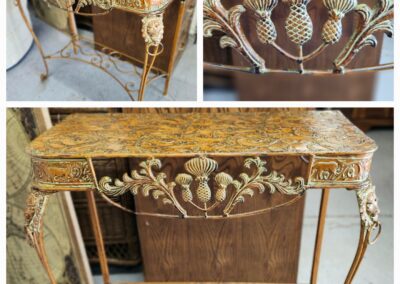 Ornate vintage metal table with intricate designs.