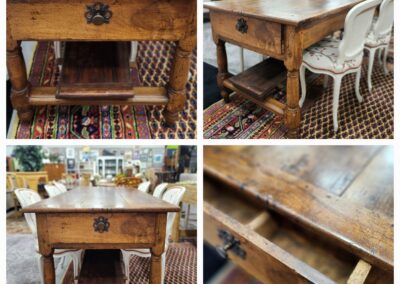 Rustic wooden table with ornate drawer handle.