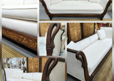 Vintage white sofa with wooden carvings.