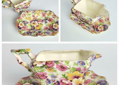 Floral-patterned gravy boat with matching saucer.